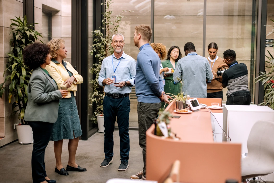 Colleagues socializing in modern office space