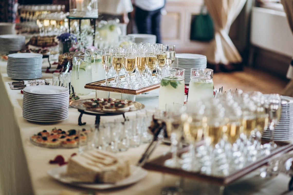 Catered event table with desserts and beverages