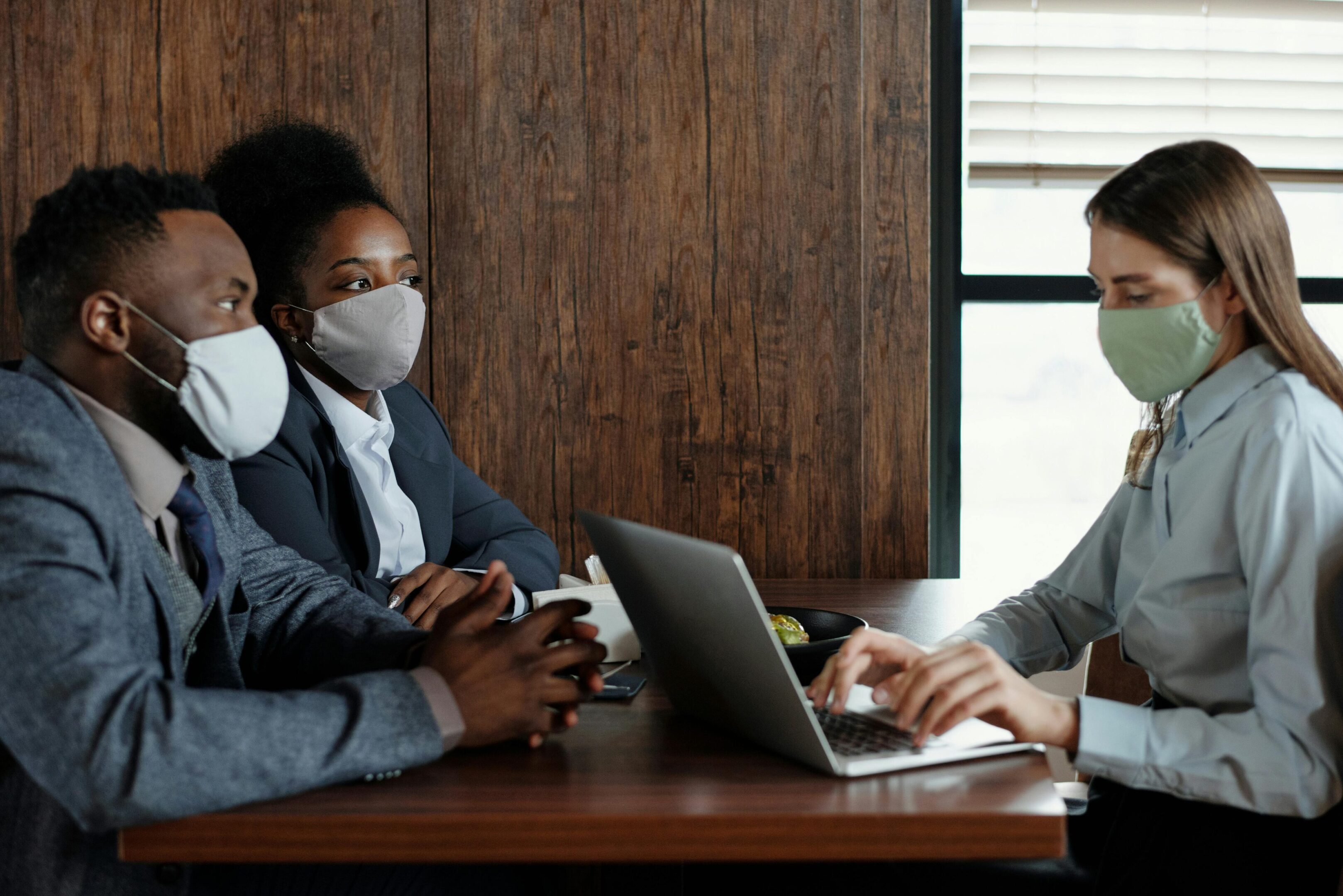 People in masks having a meeting