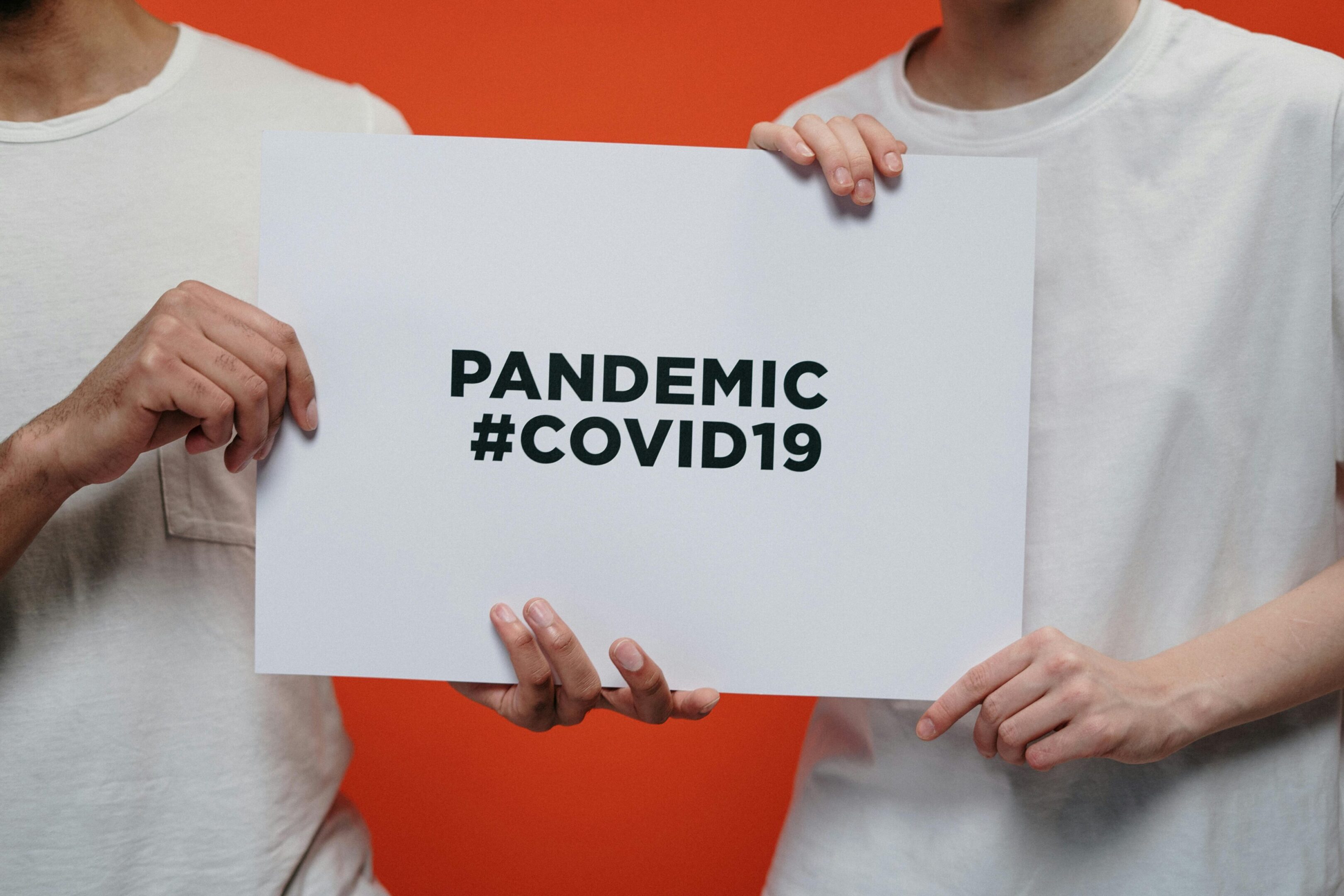 People holding COVID-19 pandemic sign
