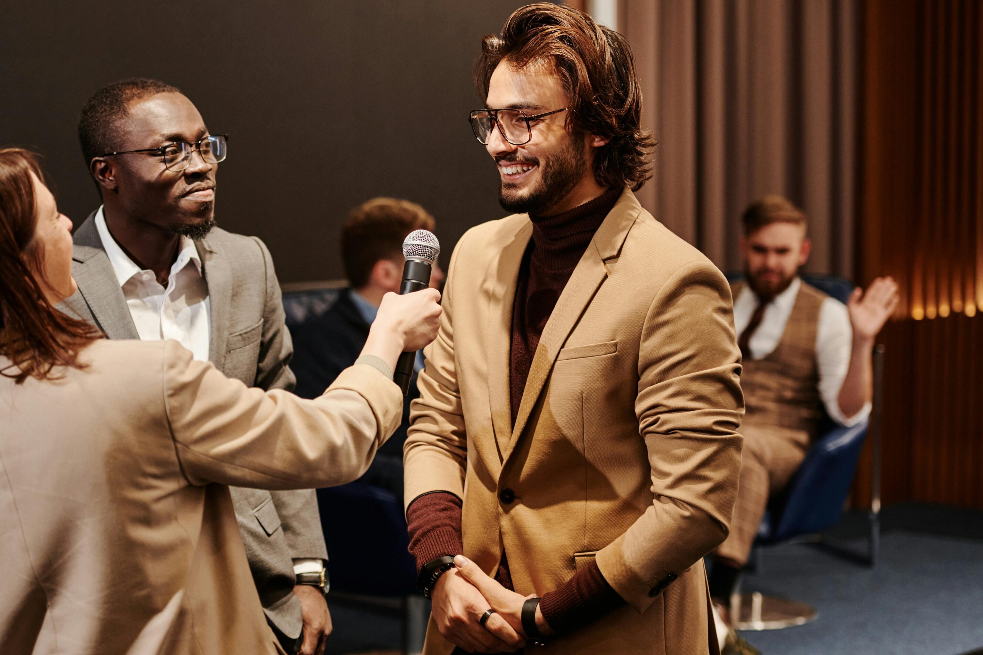 People discussing with microphone in hand